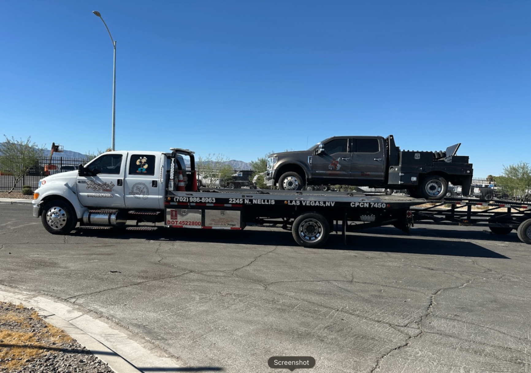 Reggie's flatbed towing a Ford Super Duty in Las Vegas, NV