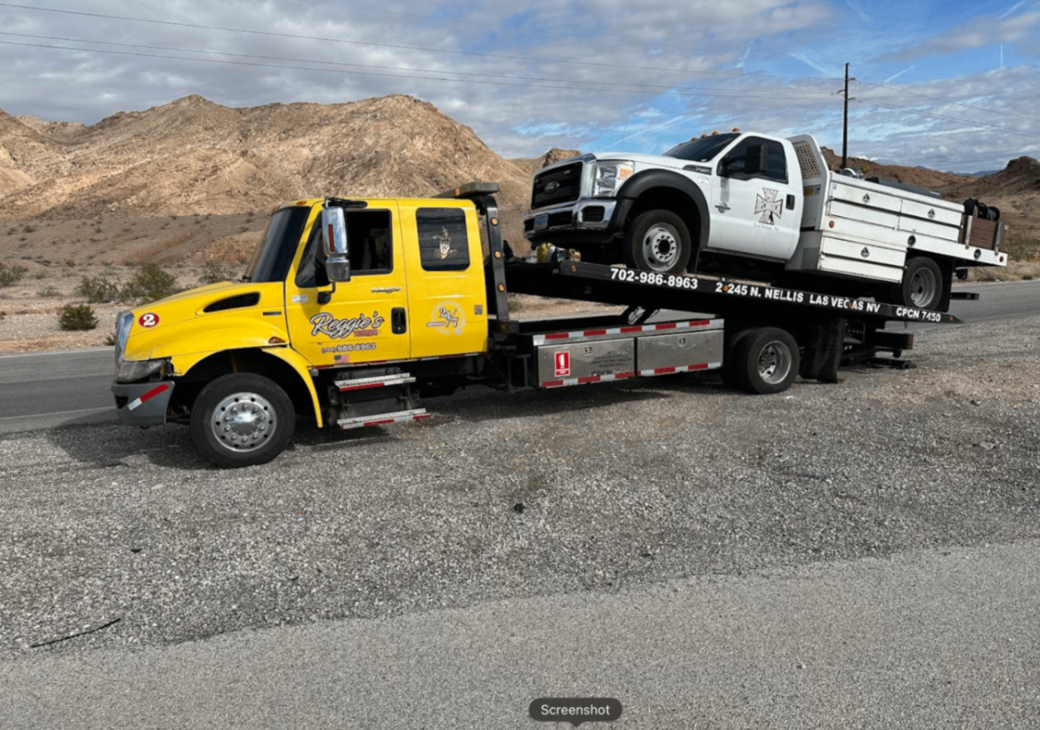 Yellow Reggie's Towing truck with Ford F-450 on flatbed