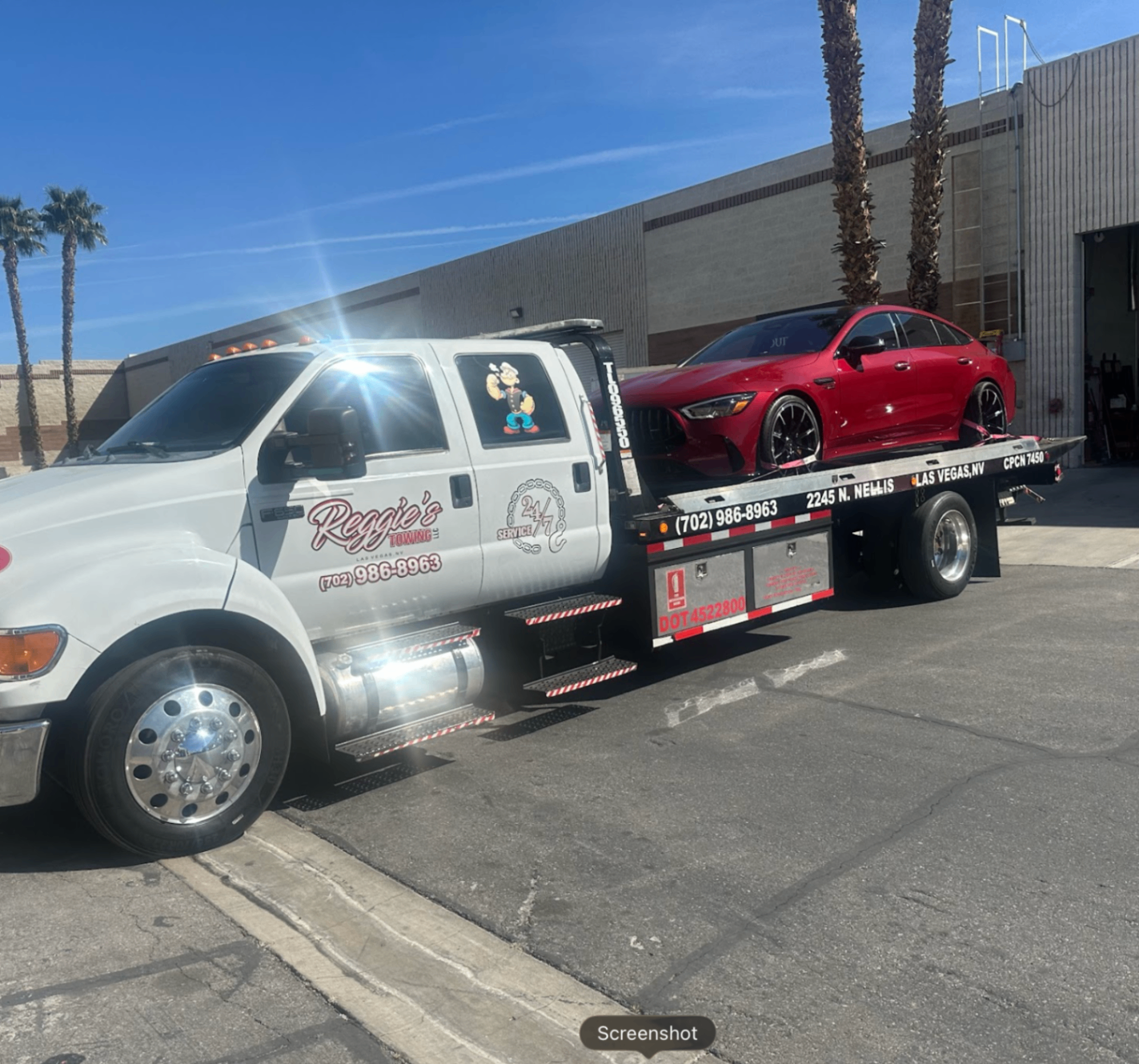 Reggie's Towing flatbed with red Mercedes-AMG GT in Las Vegas