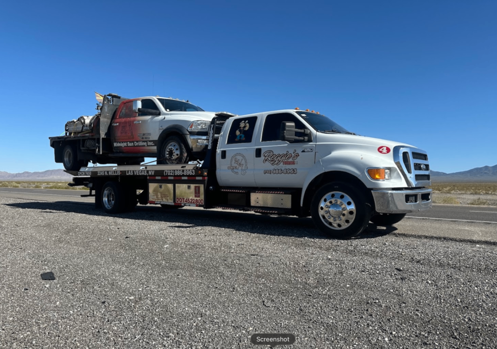 Reggie's flatbed with red Ram service truck on Nevada highway